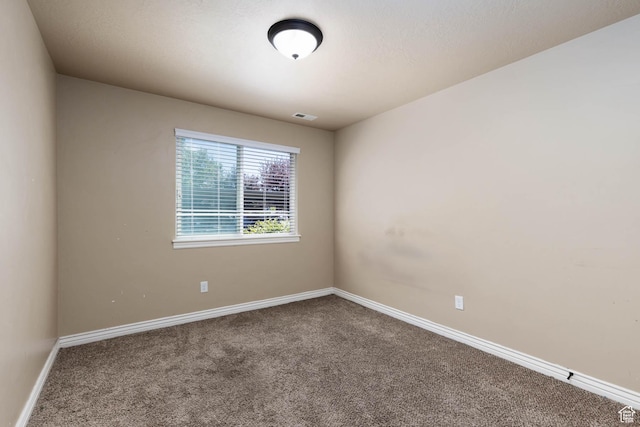 unfurnished room featuring carpet flooring, baseboards, and visible vents