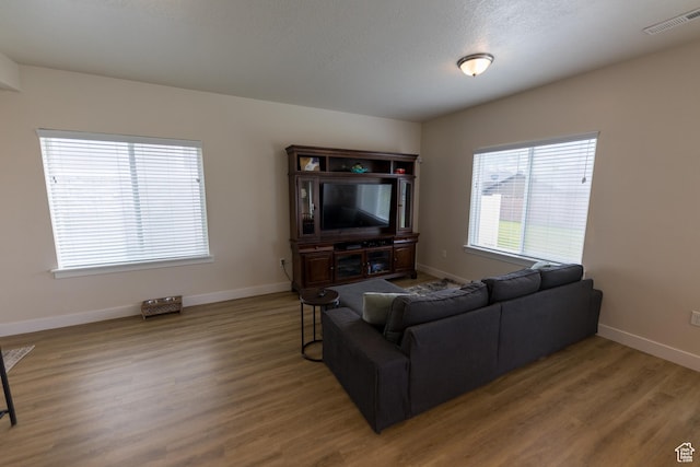 987 W 600 S, Brigham City, UT 84302 - living area with visible vents, wood finished floors, and baseboards
