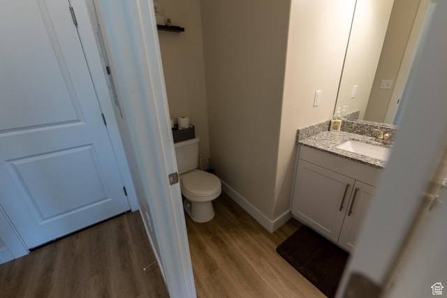 987 W 600 S, Brigham City, UT 84302 - half bath featuring vanity, toilet, baseboards, and wood finished floors
