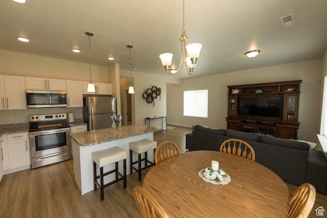 987 W 600 S, Brigham City, UT 84302 - dining area featuring recessed lighting, a chandelier, visible vents, and wood finished floors