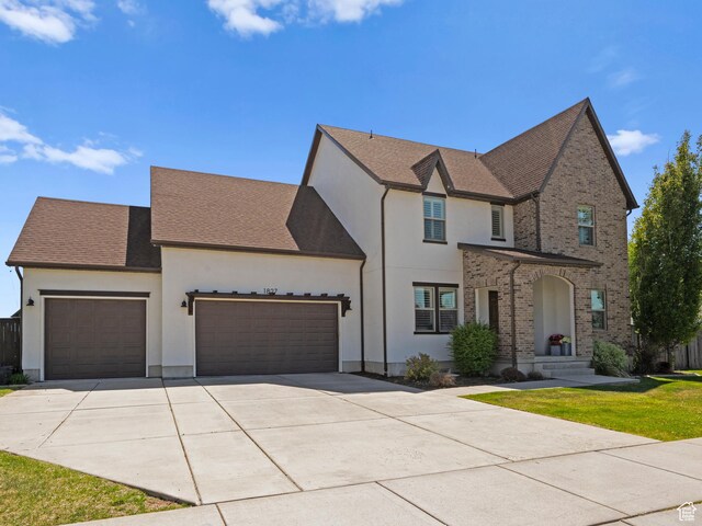 1827 W Burke Ln, Farmington, UT 84025 - traditional home with stucco siding, driveway, and a garage
