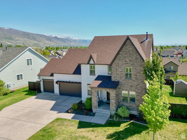 1827 W Burke Ln, Farmington, UT 84025 - view of front facade with an attached garage, concrete driveway, fence, and a front yard