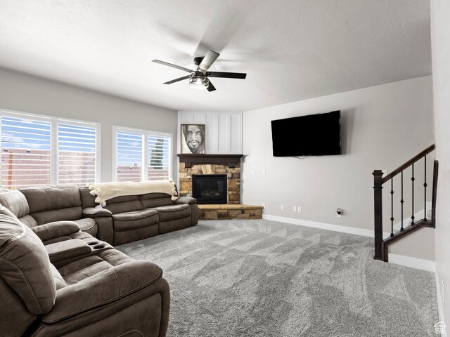 1827 W Burke Ln, Farmington, UT 84025 - carpeted living room with a fireplace, ceiling fan, stairs, and baseboards