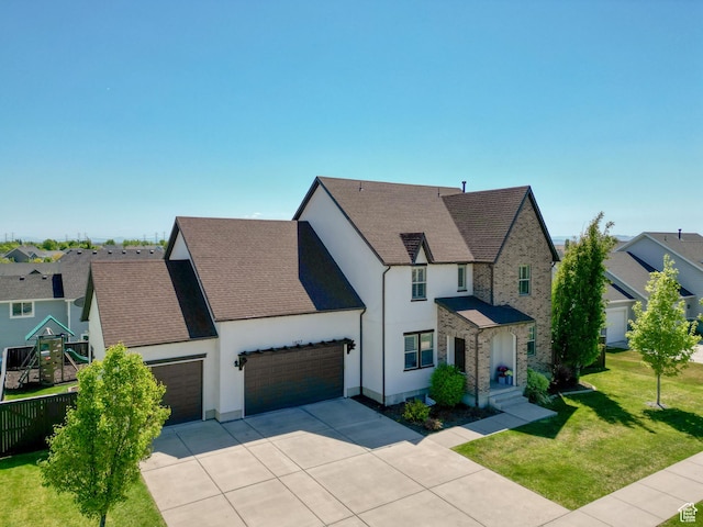 1827 W Burke Ln, Farmington, UT 84025 - view of front facade with concrete driveway, a front yard, stucco siding, and an attached garage