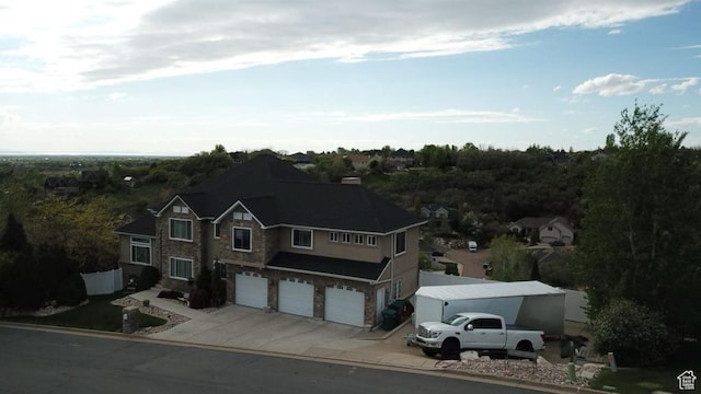 2247 Country Oaks Dr, Layton, UT 84040 - view of front of property with an attached garage, driveway, and stone siding