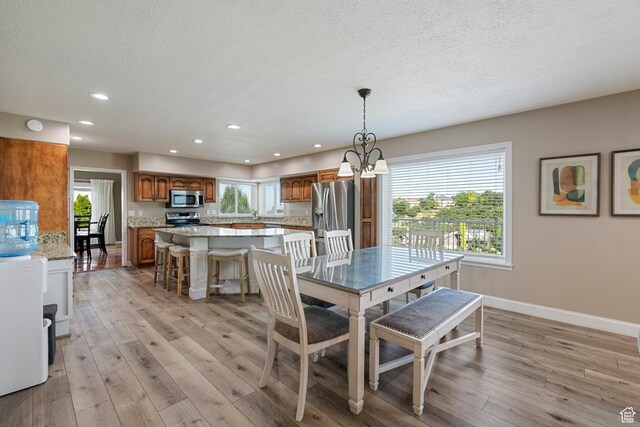 2247 Country Oaks Dr, Layton, UT 84040 - dining room featuring recessed lighting, a textured ceiling, light wood-type flooring, and a chandelier