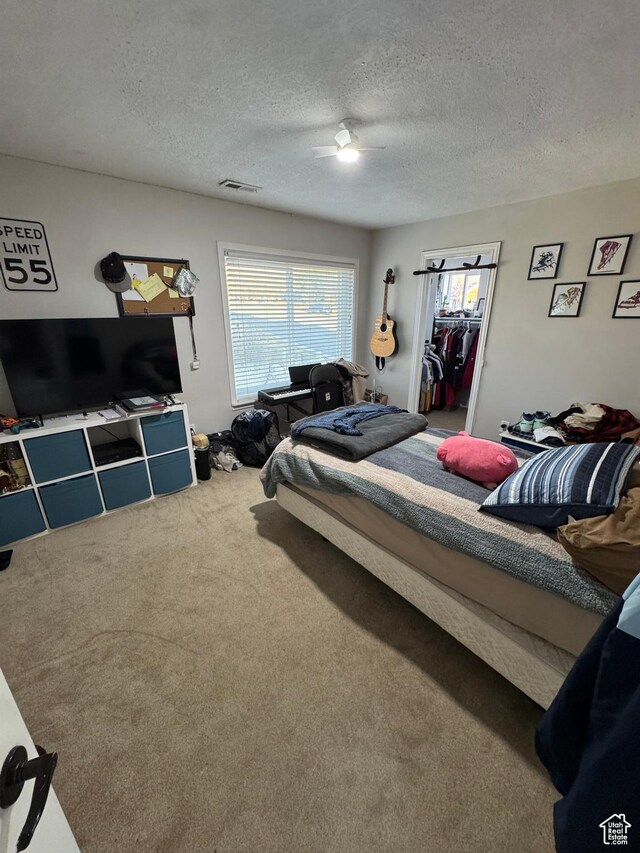2247 Country Oaks Dr, Layton, UT 84040 - bedroom with a ceiling fan, carpet flooring, visible vents, and a textured ceiling