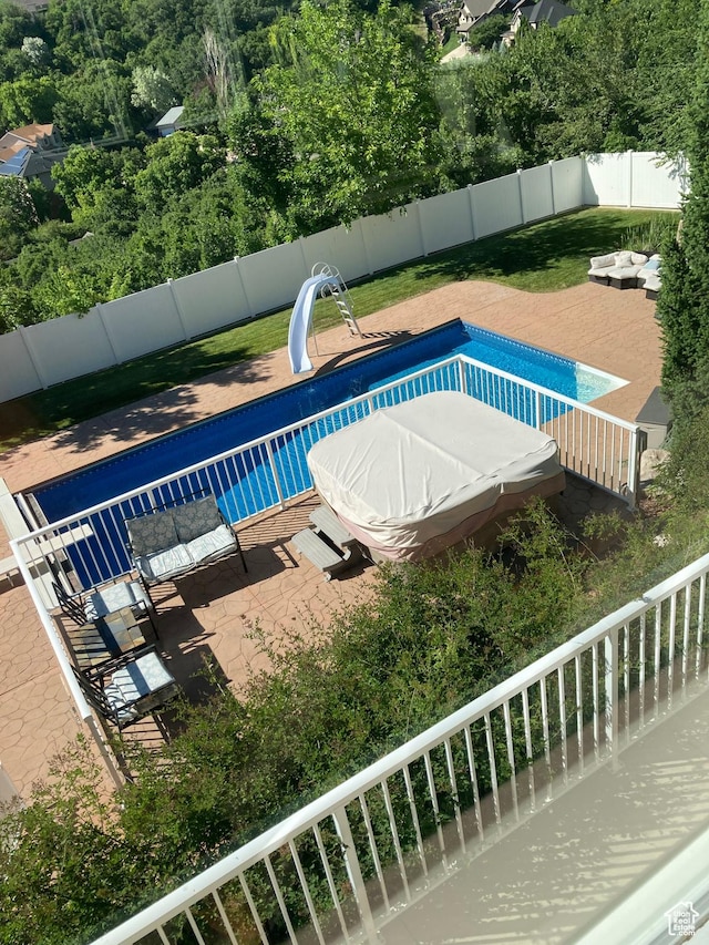 2247 Country Oaks Dr, Layton, UT 84040 - view of swimming pool featuring a water slide, a fenced in pool, and a fenced backyard