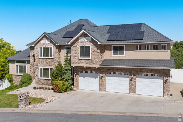 2247 Country Oaks Dr, Layton, UT 84040 - view of front of property with stone siding, a garage, and concrete driveway