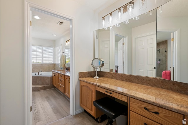 2247 Country Oaks Dr, Layton, UT 84040 - full bath with a garden tub, wood finished floors, a shower stall, and vanity