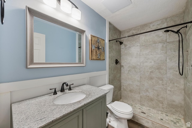 2247 Country Oaks Dr, Layton, UT 84040 - full bath with vanity, a tile shower, wainscoting, and a textured ceiling
