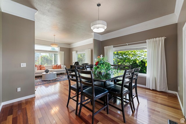 2247 Country Oaks Dr, Layton, UT 84040 - dining room with wood-type flooring, a textured ceiling, and crown molding