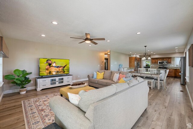 2247 Country Oaks Dr, Layton, UT 84040 - living room with light wood-style floors, recessed lighting, and a ceiling fan