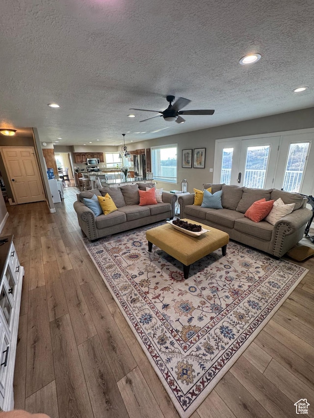 2247 Country Oaks Dr, Layton, UT 84040 - living area with hardwood / wood-style flooring, ceiling fan, and a textured ceiling