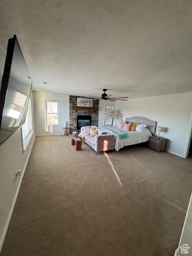 2247 Country Oaks Dr, Layton, UT 84040 - bedroom with a textured ceiling, a fireplace, carpet floors, a ceiling fan, and baseboards