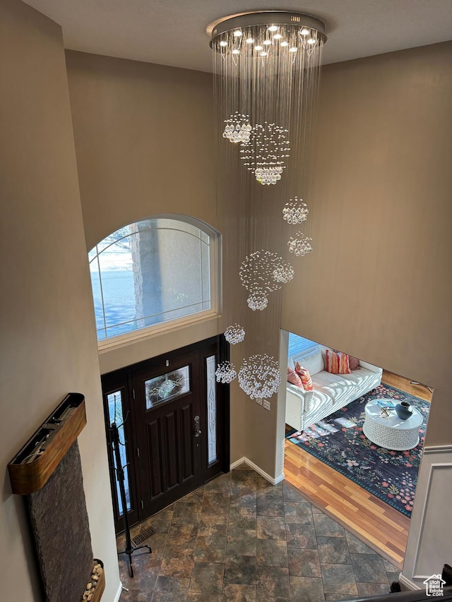 2247 Country Oaks Dr, Layton, UT 84040 - foyer with a chandelier, baseboards, and stone finish floor
