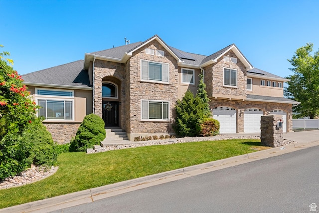 2247 Country Oaks Dr, Layton, UT 84040 - view of front of home with stone siding, a front lawn, an attached garage, concrete driveway, and roof mounted solar panels