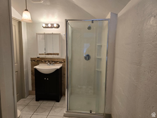 1111 S Redwood Dr, Salt Lake City, UT 84104 - full bathroom featuring a stall shower, vanity, a textured wall, and marble finish floor