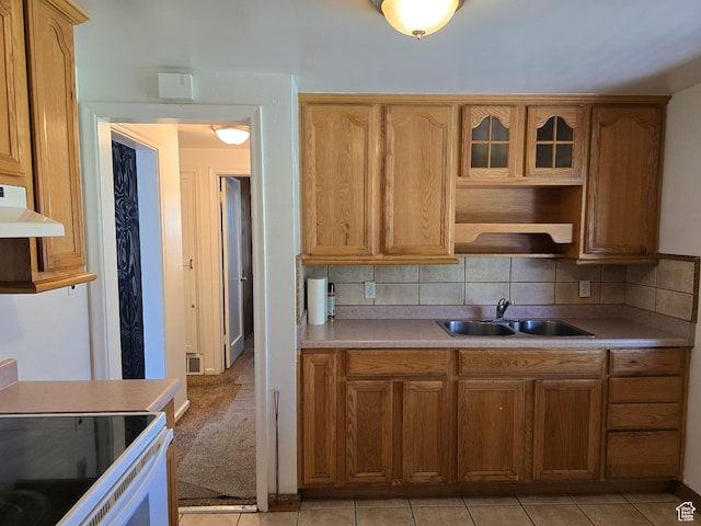 1111 S Redwood Dr, Salt Lake City, UT 84104 - kitchen featuring a sink, under cabinet range hood, backsplash, light countertops, and white range with electric stovetop
