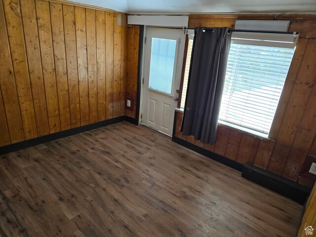 1111 S Redwood Dr, Salt Lake City, UT 84104 - empty room with a wealth of natural light, wooden walls, and wood finished floors