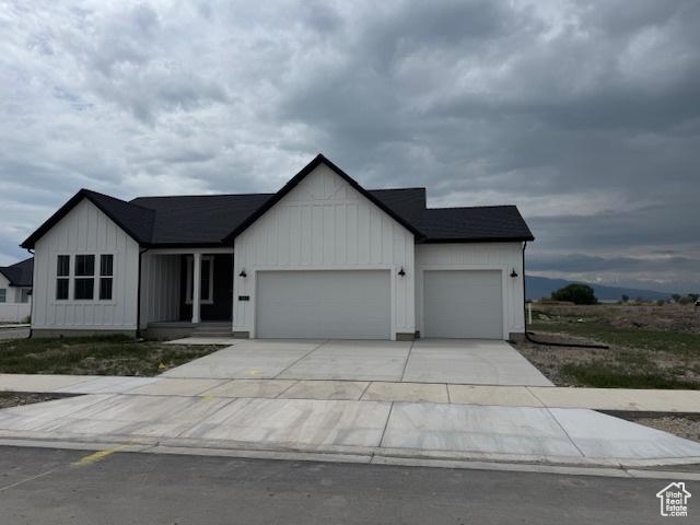 view of front of house featuring concrete driveway, board and batten siding, and an attached garage
