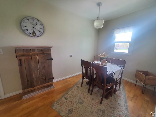 dining room with light wood-type flooring and baseboards