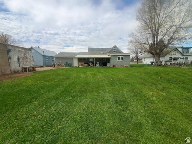 rear view of property with a yard and fence