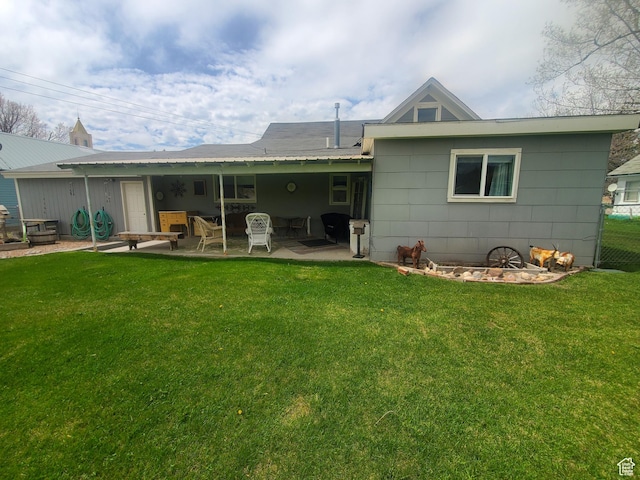 back of house with a patio area, fence, and a lawn