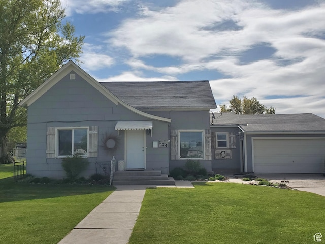 174 N 5th St, Montpelier, ID 83254 - view of front of house featuring concrete driveway, an attached garage, a front yard, and roof with shingles