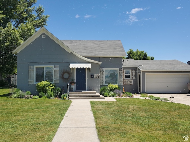 174 N 5th St, Montpelier, ID 83254 - view of front facade featuring a front lawn, an attached garage, a shingled roof, and concrete driveway
