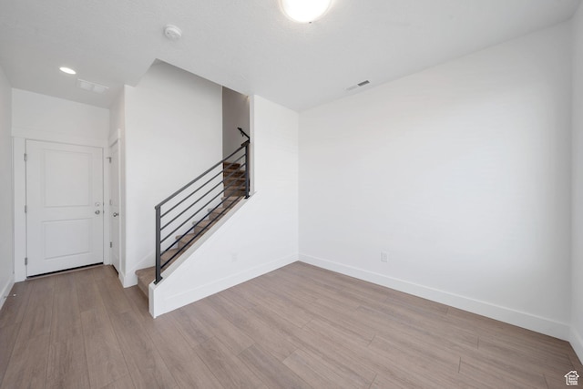interior space featuring wood finished floors, visible vents, and baseboards