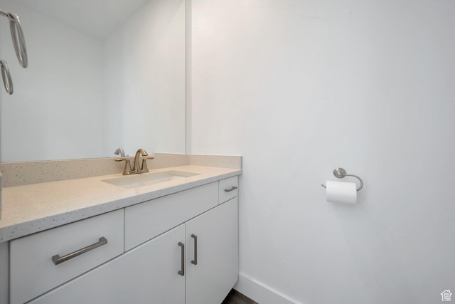 bathroom featuring baseboards and vanity