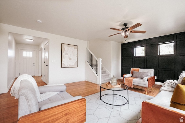 235 E Caracara St S, Saratoga Springs, UT 84043 - living area featuring light wood-type flooring, a decorative wall, ceiling fan, and stairs