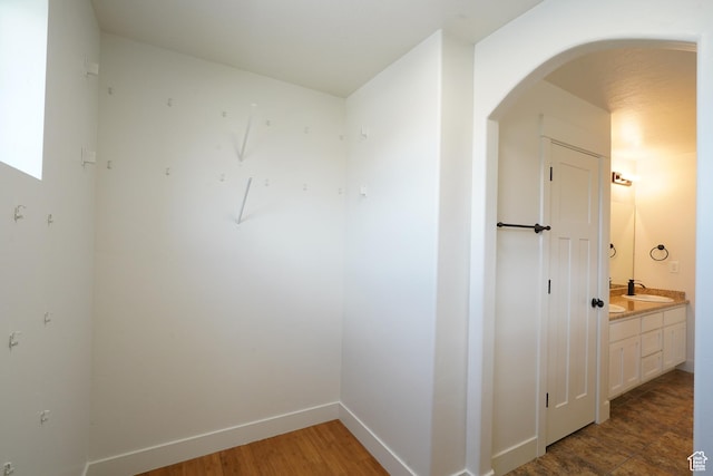 235 E Caracara St S, Saratoga Springs, UT 84043 - interior space with baseboards, arched walkways, and a sink