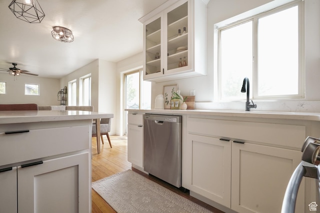 235 E Caracara St S, Saratoga Springs, UT 84043 - kitchen featuring a sink, ceiling fan, light countertops, stainless steel dishwasher, and light wood-style floors