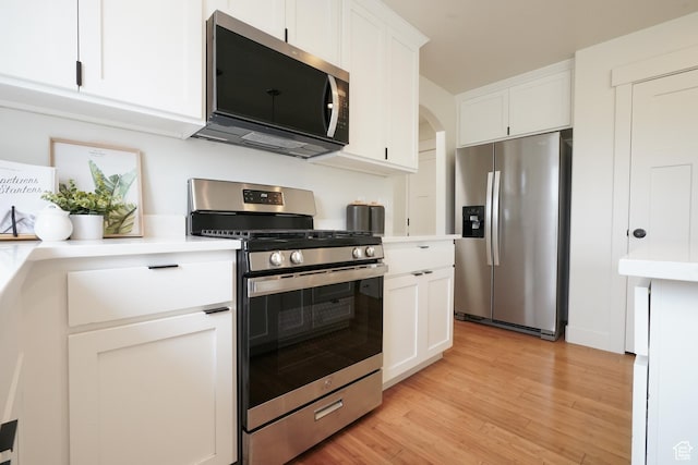 235 E Caracara St S, Saratoga Springs, UT 84043 - kitchen with light wood finished floors, light countertops, stainless steel appliances, and white cabinets