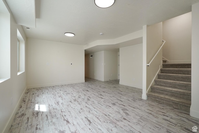 235 E Caracara St S, Saratoga Springs, UT 84043 - unfurnished living room with stairs, baseboards, and wood finished floors