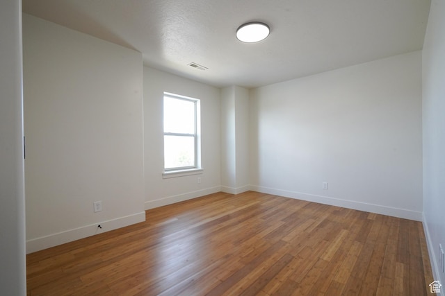 235 E Caracara St S, Saratoga Springs, UT 84043 - spare room with wood finished floors, visible vents, and baseboards