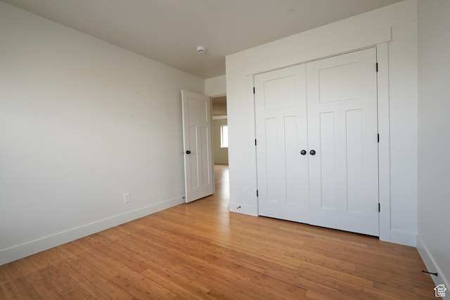 235 E Caracara St S, Saratoga Springs, UT 84043 - unfurnished bedroom with baseboards, a closet, and light wood-style floors