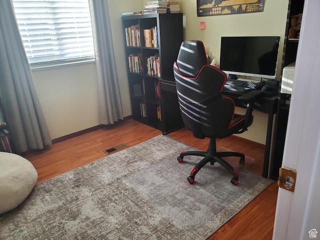 office area featuring visible vents and wood finished floors