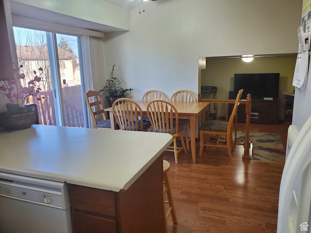 kitchen with a peninsula, light countertops, wood finished floors, ceiling fan, and dishwasher