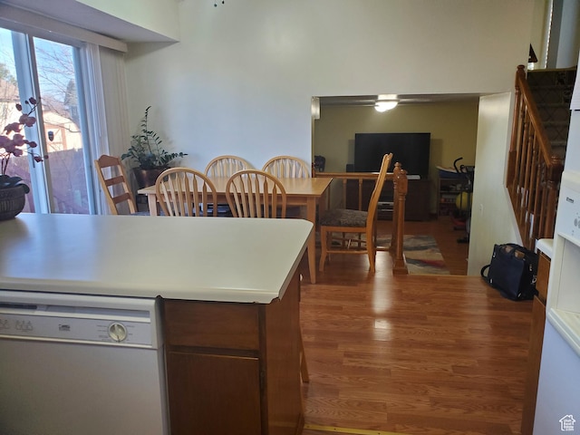 kitchen with wood finished floors, light countertops, and dishwasher