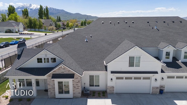 814 E 110 S, Salem, UT 84653 - view of front of home with a mountain view, a garage, a shingled roof, concrete driveway, and stone siding