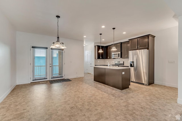 kitchen featuring dark brown cabinets, an island with sink, baseboards, light countertops, and appliances with stainless steel finishes