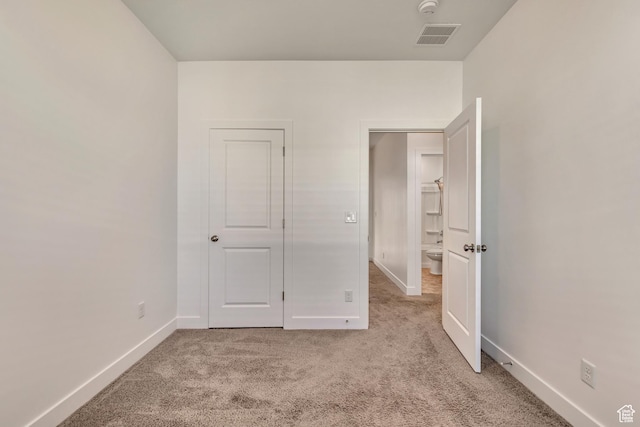 unfurnished bedroom featuring light carpet, baseboards, and visible vents