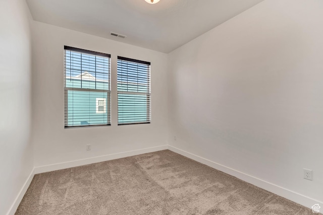 carpeted empty room with baseboards and visible vents
