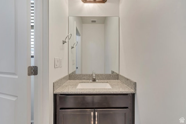 bathroom featuring vanity and visible vents