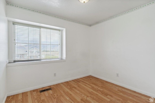 3035 N 2575 W, Farr West, UT 84404 - empty room with light wood finished floors, visible vents, and baseboards