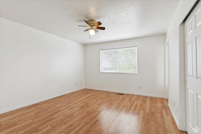 3035 N 2575 W, Farr West, UT 84404 - spare room with a textured ceiling, light wood-type flooring, visible vents, a ceiling fan, and baseboards