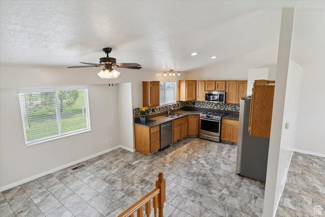 3035 N 2575 W, Farr West, UT 84404 - kitchen featuring baseboards, a sink, dark countertops, tasteful backsplash, and appliances with stainless steel finishes
